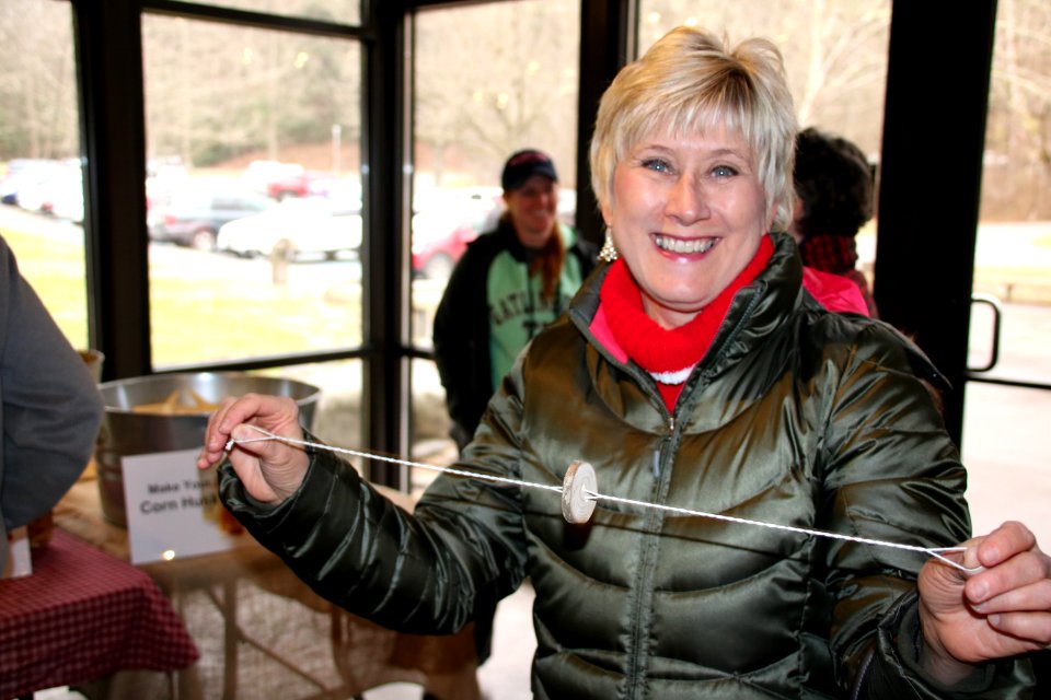 A visitor smiles with a buzz button at the 2018 Festival of Christmas Past, December 8, 2018--Warren Bielenberg