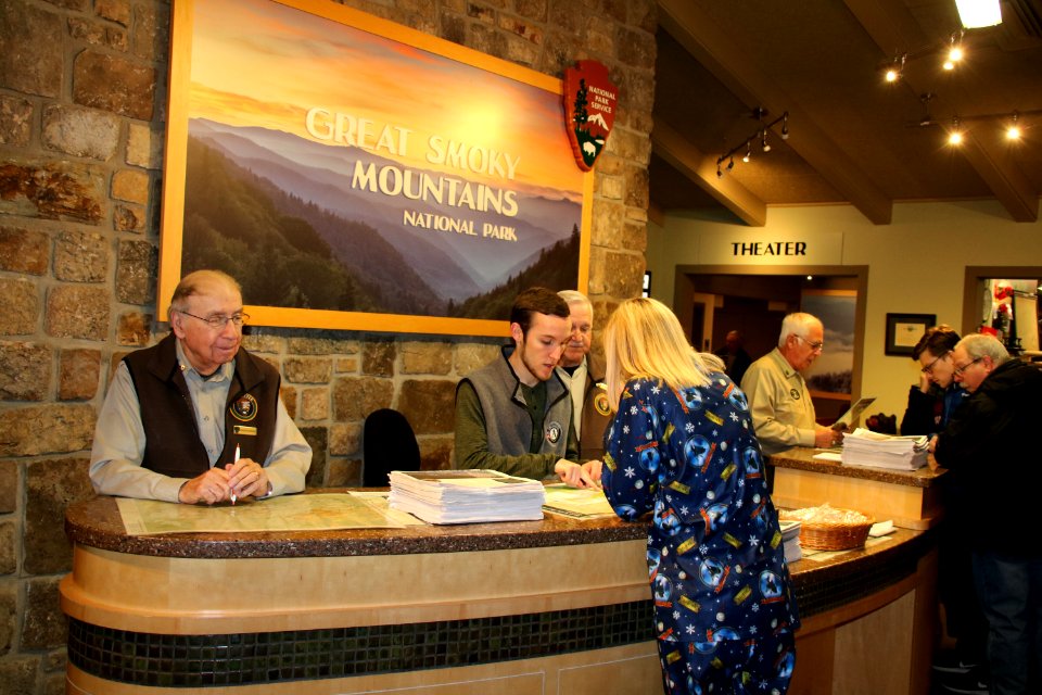 Volunteer Merwyn Borders, AmeriCorps crew member Erin Waddell, Volunteer Wayne "Sarge" Wolfe, and Volunteer Pat Carbone assist visitors at the 2018 Festival of Christmas Past, December 8, 2018--Warren Bielenberg