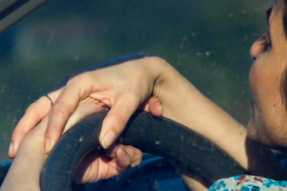 Fingers on the steering wheel