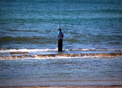 Fisherman on rocks -Hadera photo