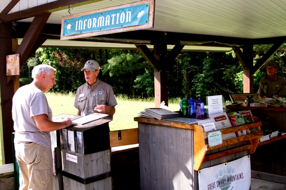 Great Smoky Mountains Association employee assists visitor at Cades Cove Orientation Shelter, June 2013--Warren Bielenberg