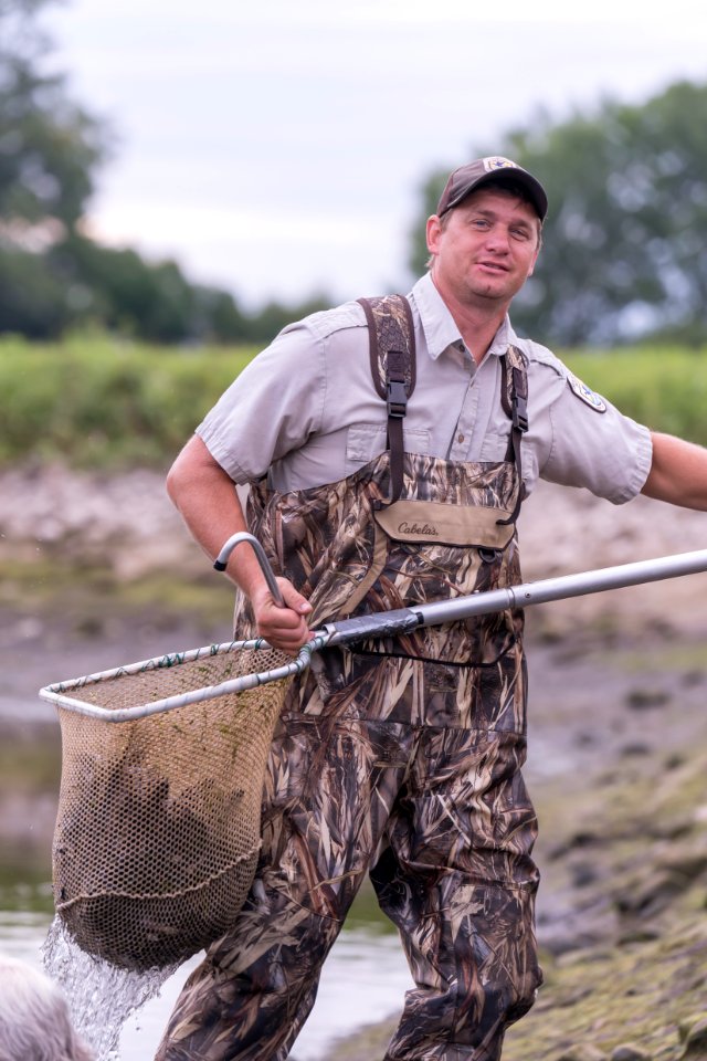 Nick Starzl With a Net Full of Paddlefish