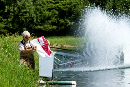 Filling a fish feeder at Gavins Point NFH photo