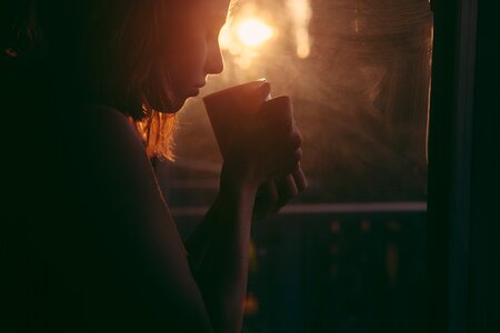 Coffee cup sunset sad woman