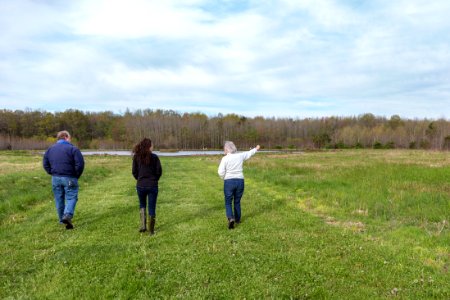 Marilyn Spong walks with Megan Lang (USFWS), and Greg McCarty (USDA) around the restored wetland