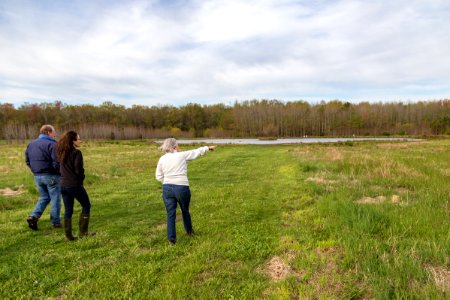 Marilyn Spong walks with Megan Lang (USFWS), and Greg McCarty (USDA) around the restored wetland