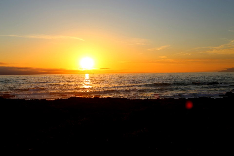 Sunset over the Pacific Ocean and the California Coastal National Monument viewed from the Piedras Blancas Light Station Outstanding Natural Area
