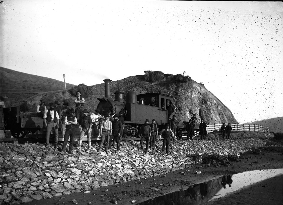 58; Group of men standing front of Train engine