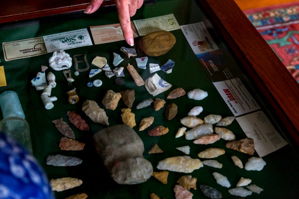 Marilyn shows off artifacts found on their property, arrowheads, tools, and more