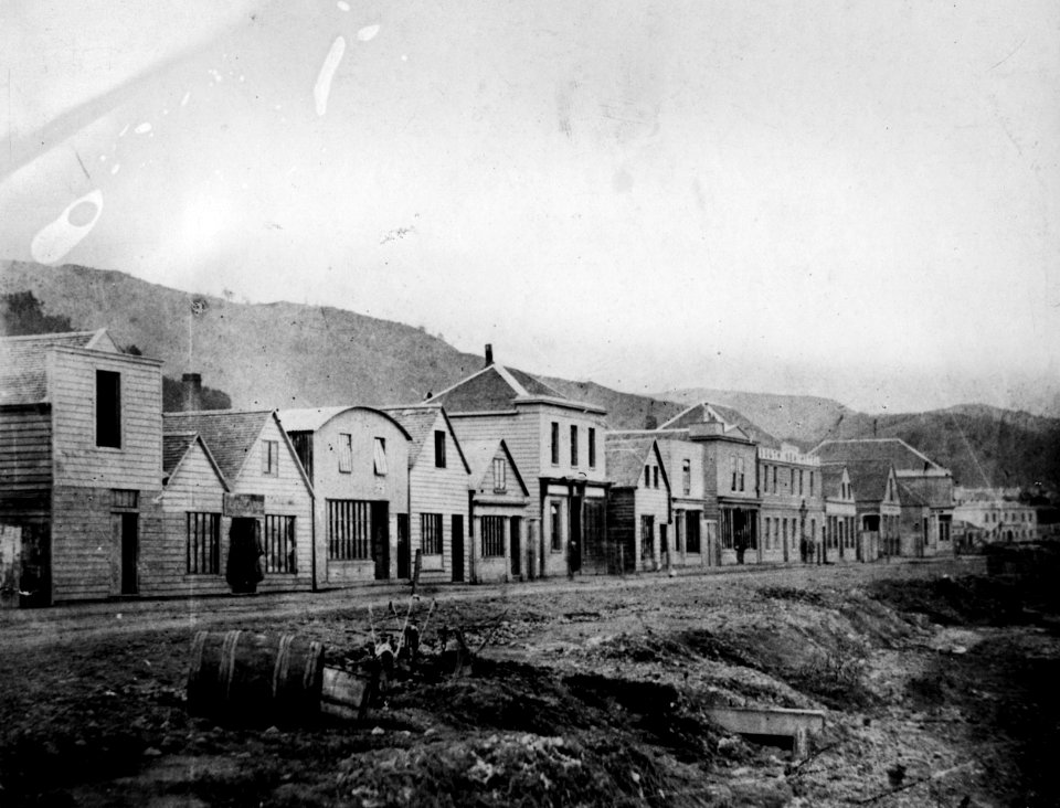 135; Wooden shops on Lambton Quay, opposite coastline - 1860s