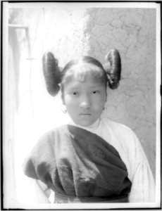 Young Hopi Indian girl with hair worn up in large buns at the side of her head, ca.1900 (CHS-3701)