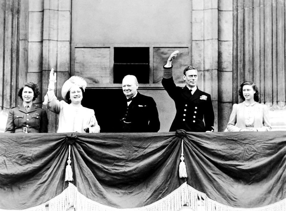 King George VI and Queen Elizabeth with Princesses Elizabeth and Margaret joined by Winston Churchill on the balcony of Buckingham Palace, London on VE Day, May 8, 1945