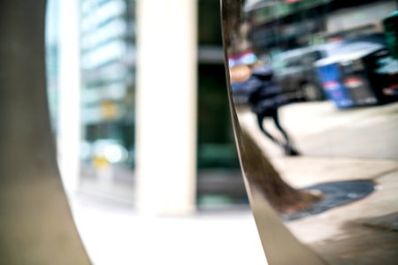 Reflection of woman in sculpture n Wall Street photo