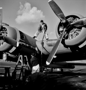 Fill er Up: Lubricating and servicing a new B-17F (Flying Fortress) bomber for flight tests at the airfield of Boeing's Seattle plant. 1942. photo