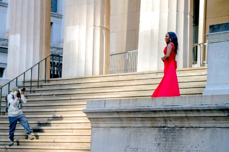 Beautiful woman in red dress with photographer at Federal Hall photo