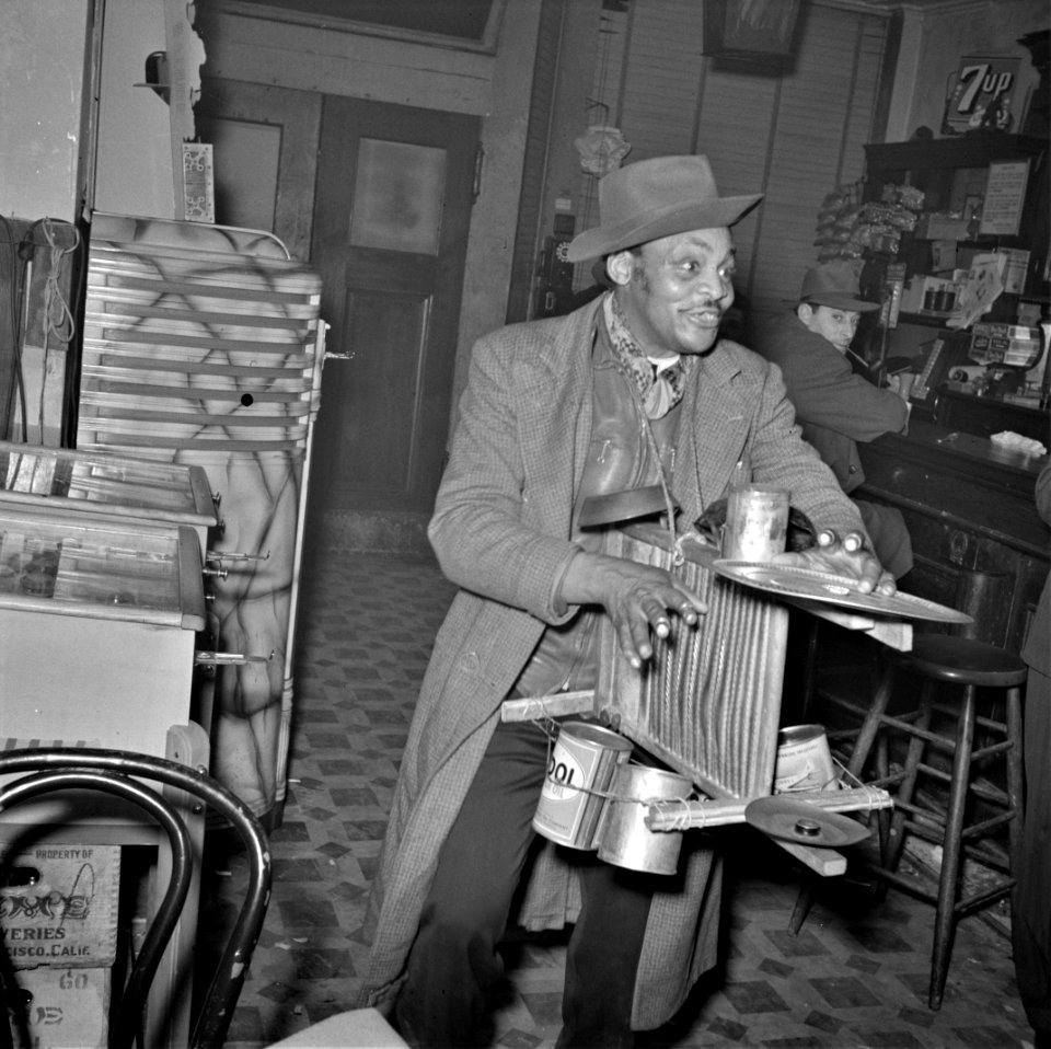 The Soloist: A One man tin can band during a wartime blackout. San Francisco, California, December 1941.