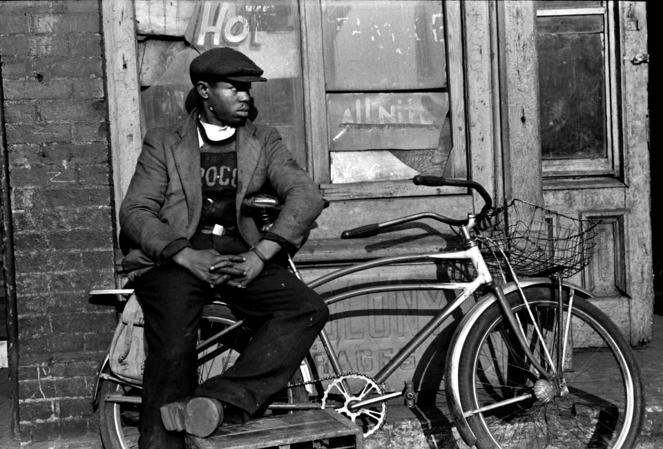 Hot All Nite: Young man with his bicycle on 47th Street, Chicago, Illinois, 1941.