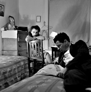 News Muse: Reading the newspaper aloud in a boardinghouse room. Washington, D.C., January 1943.