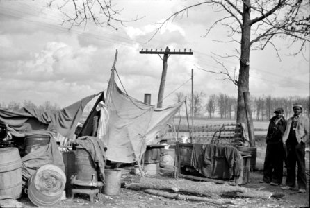 Evicted: State highway officials moving evicted Black sharecroppers away from roadside to area between the levee and the Mississippi River. New Madrid County, Missouri, 1938.