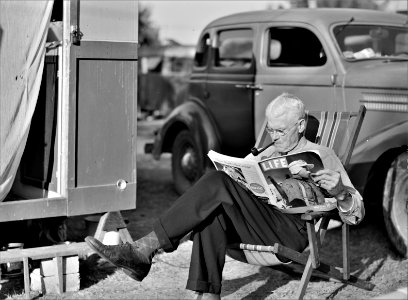 The Easy Life: Winter tourist reading a magazine beside his trailer home. Sarasota trailer park, Sarasota, Florida, January 1941.