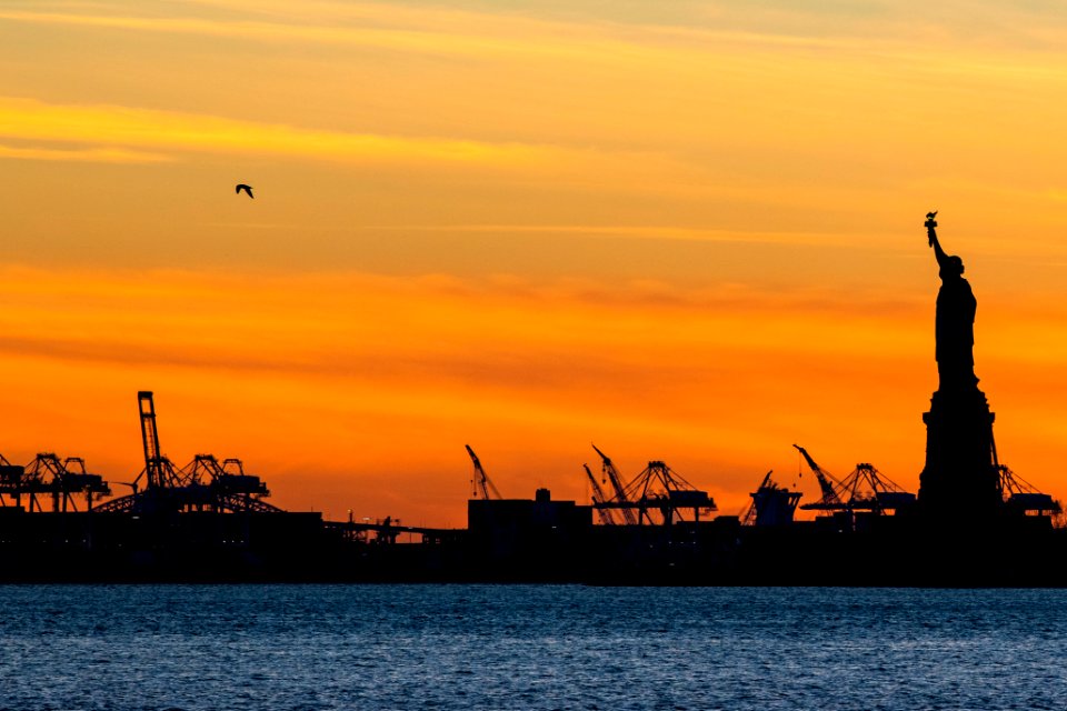 Statue of Liberty and cranes at docks in Jersey