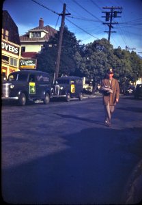 1940's Kodachrome slide showing a serviceman walking down a street in uniform. Likely taken during WWII. photo