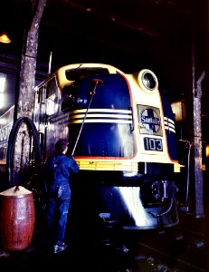 Bath Time: Washing one of the Santa Fe R.R. 54 hundred horse power diesel freight locomotives in the roundhouse, Argentine, Kansas. Argentine yard is at Kansas City, Kansas, March 1943.