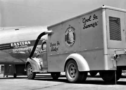 Cool in Summer: Keeping the airliner air-conditioned while it is on the ground. Municipal airport, Washington, D.C., July 1941.