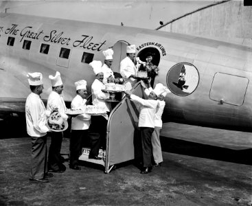 Let Them Eat Cake: Cakes for sky riders. Washington, D.C., Oct. 4. Air travelers leaving Washington Airport during National Air Travel Week, Oct. 2. 9 are being given a special treat. 1938. photo