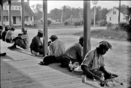 Workmen's Lunch: Migratory agricultural workers having supper at the store in Belcross, North Carolina, 1940.