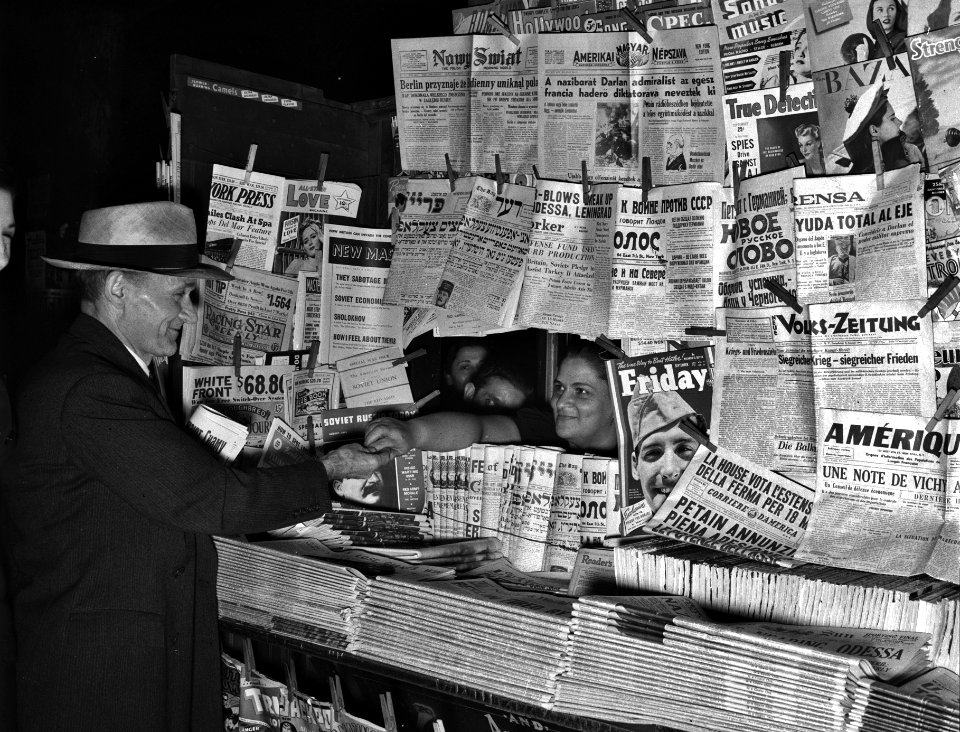 World Headlines: Newsstand with foreign language newspapers, Fall 1941.