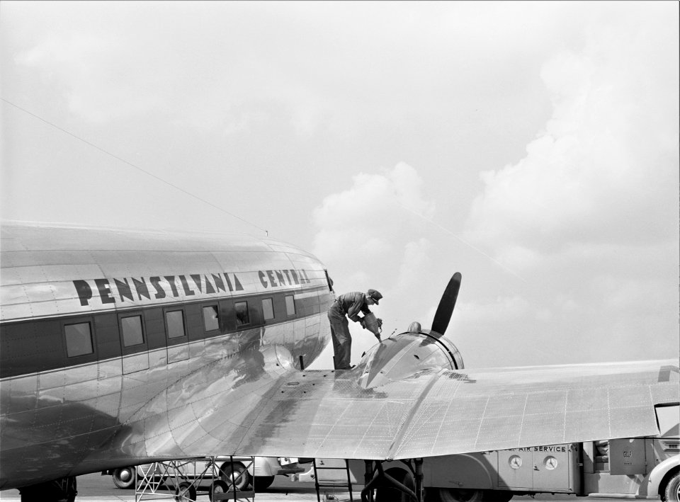 Pre-fight: Oil for the engine of an airliner preparatory to takeoff. Municipal airport, Washington, D.C. July 1941.