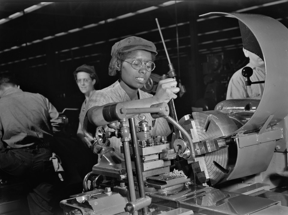 Women in war. Supercharger plant workers. Plant foremen regard 20-year-old Annie Tabor as one of their best lathe operators, despite her lack of previous industrial experience. October 1942.