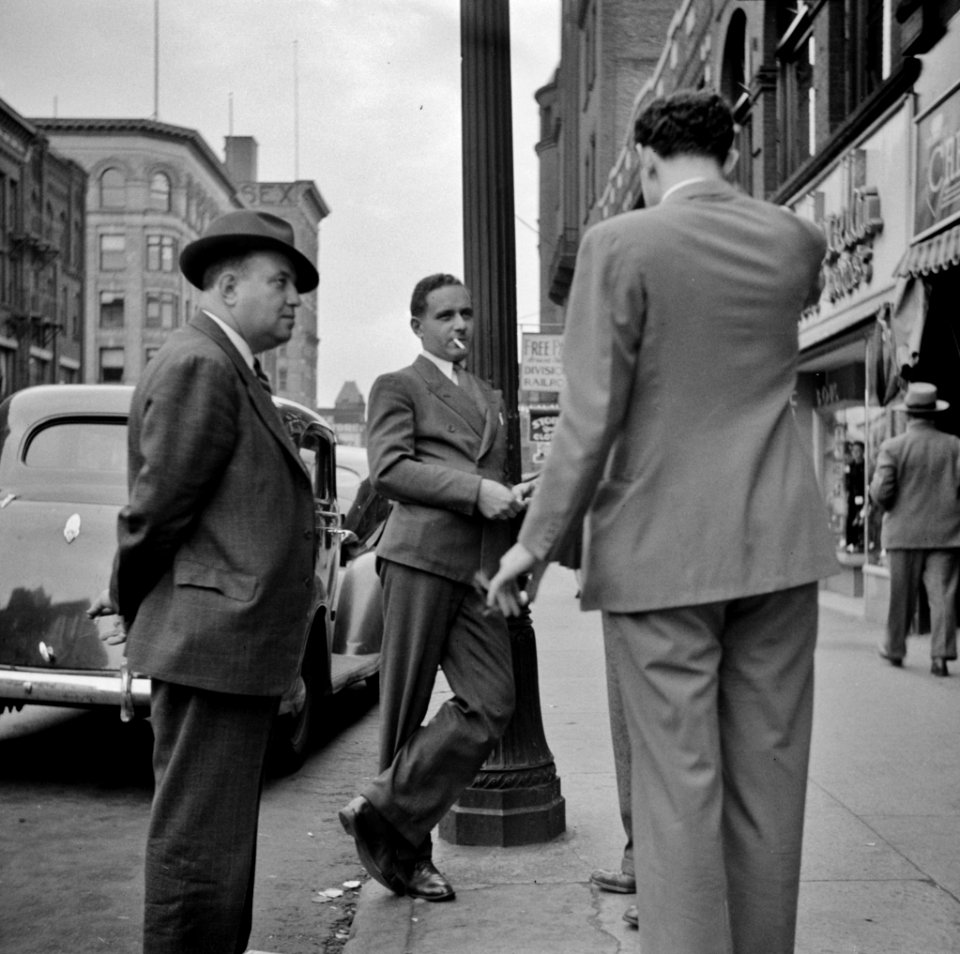 Men talk in a Street scene. Holyoke, Massachusetts, September 1941.