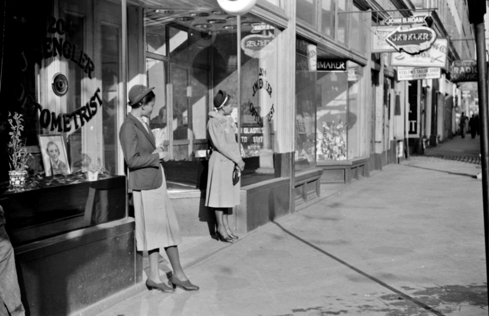 Domestic servants waiting for a streetcar on their way to work early in the morning. Mitchell Street, Atlanta, Georgia 1939.