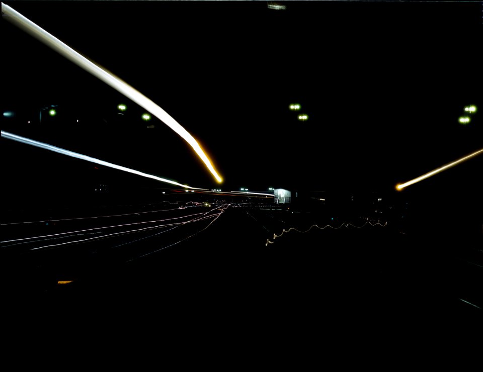 Night Moves: Activity in the Santa Fe R.R. yard, Los Angeles, Calif. All switch lights, head lights and lamps have been shaded from above in accordance with blackout regulations. March 1943
