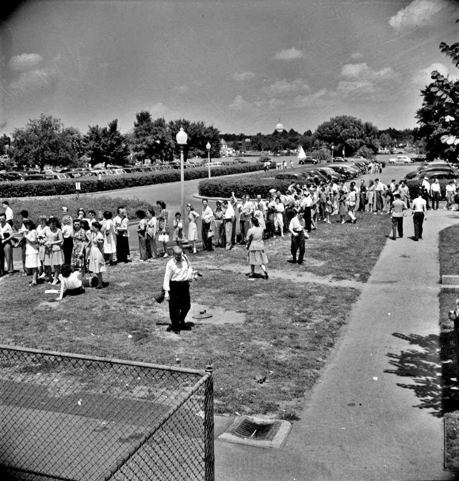 Line of prospective swimmers, awaiting their turn at the municipal swimming pool on Sunday in Washington, D.C., June 1942.