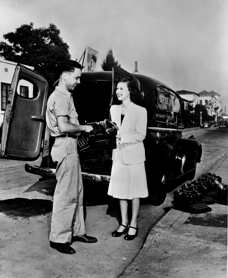 Susan Hayward, Paramount motion picture star, does her share in sending typewriters to war. 1942.