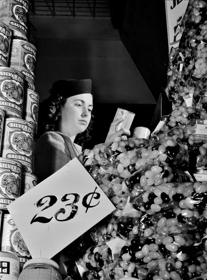 Deception: A shopper examines food labels to determine the best fit for her household's nutrition plan. February 1942. This photo was taken as part of a series to inform the public on tips for the conservation of resources during wartime. Original caption