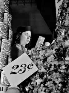 Deception: A shopper examines food labels to determine the best fit for her household's nutrition plan. February 1942. This photo was taken as part of a series to inform the public on tips for the conservation of resources during wartime. Original caption