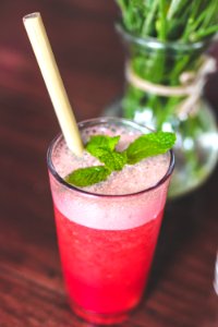 Raspberry lemonade on a wooden table. Iced summer drink. photo