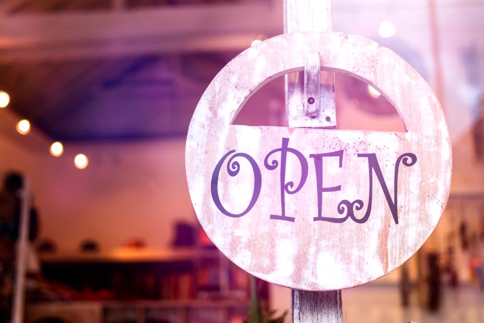 Open sign broad through the glass of window at the shop. photo