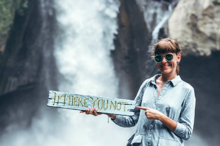 Young woman posing close to waterfall on Bali island. photo