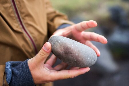 Hand hands holding stone