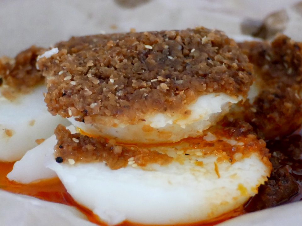 Rice cake with preserved radish topping and chilli sauce is a popular local hawker food