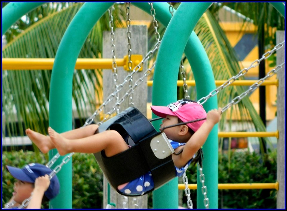 little girl having a swing time photo