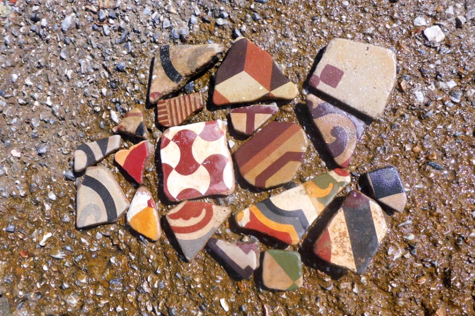 debris of old fashioned colourful tiles found all around Small Caraburnu cape in Thessaloniki