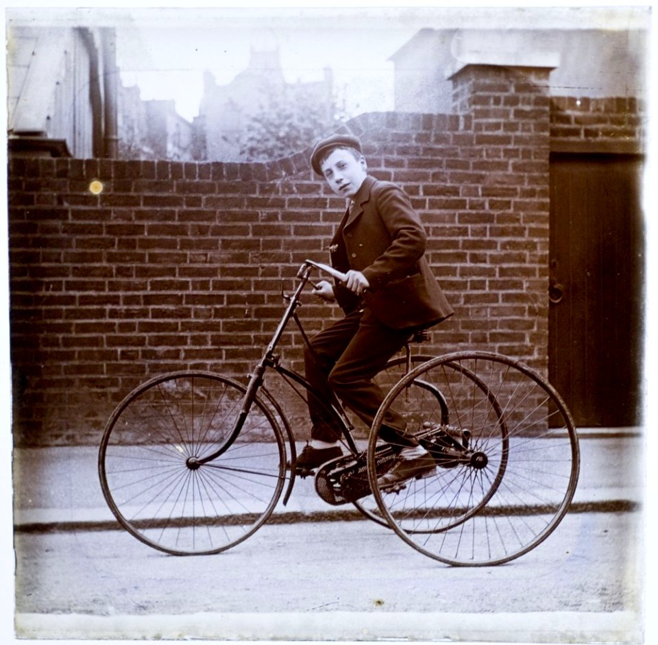 Young lad on an early tricycle