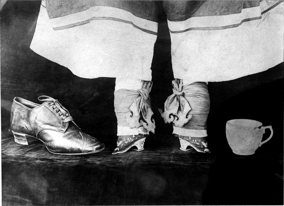 Chinese girl's feet, a men's shoe and a cup