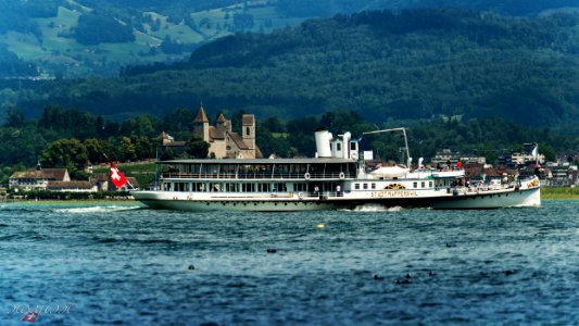Castle Rapperswil and paddle steamer on lake Zurich, Switzerland photo